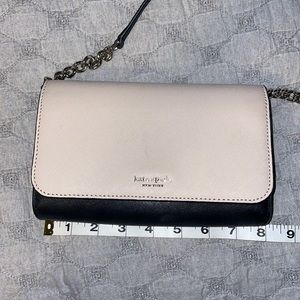 Black and light pink cross body Kate spade purse.